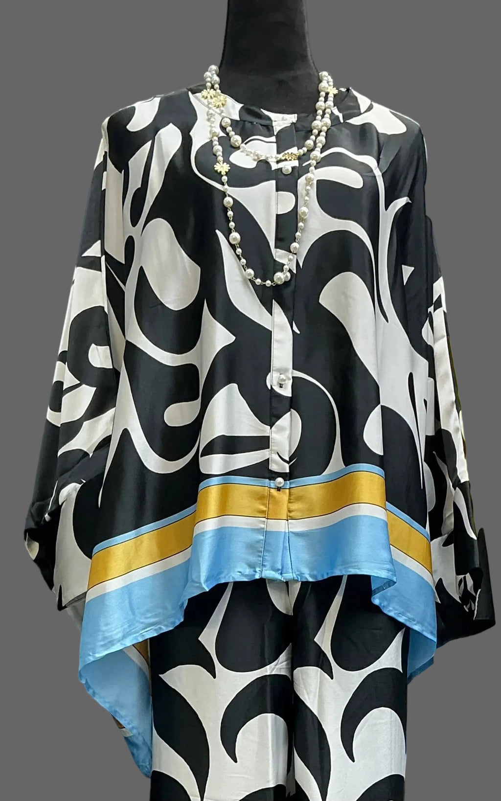 Black and white patterned top with blue and gold accents