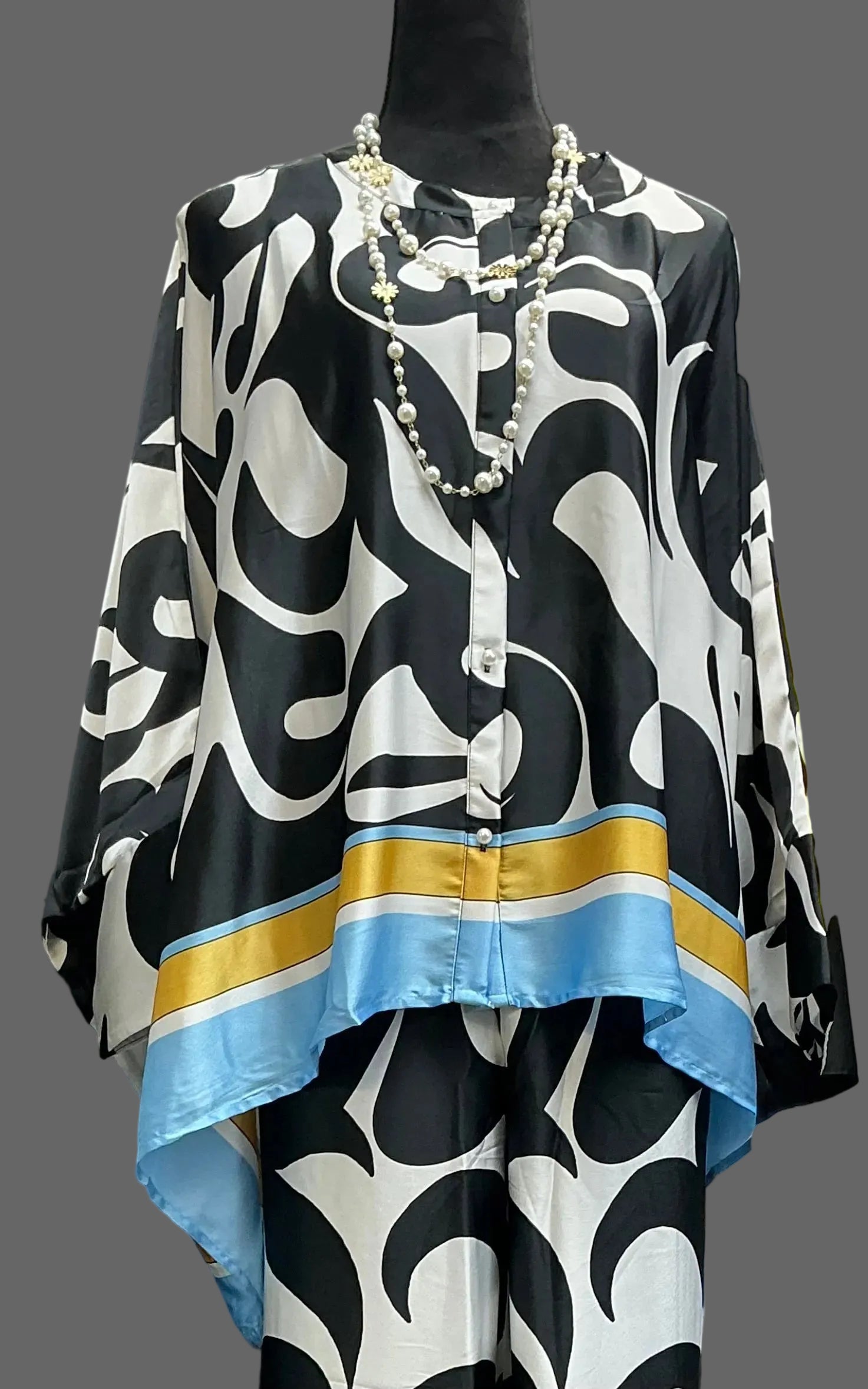 Black and white patterned top with blue and gold accents