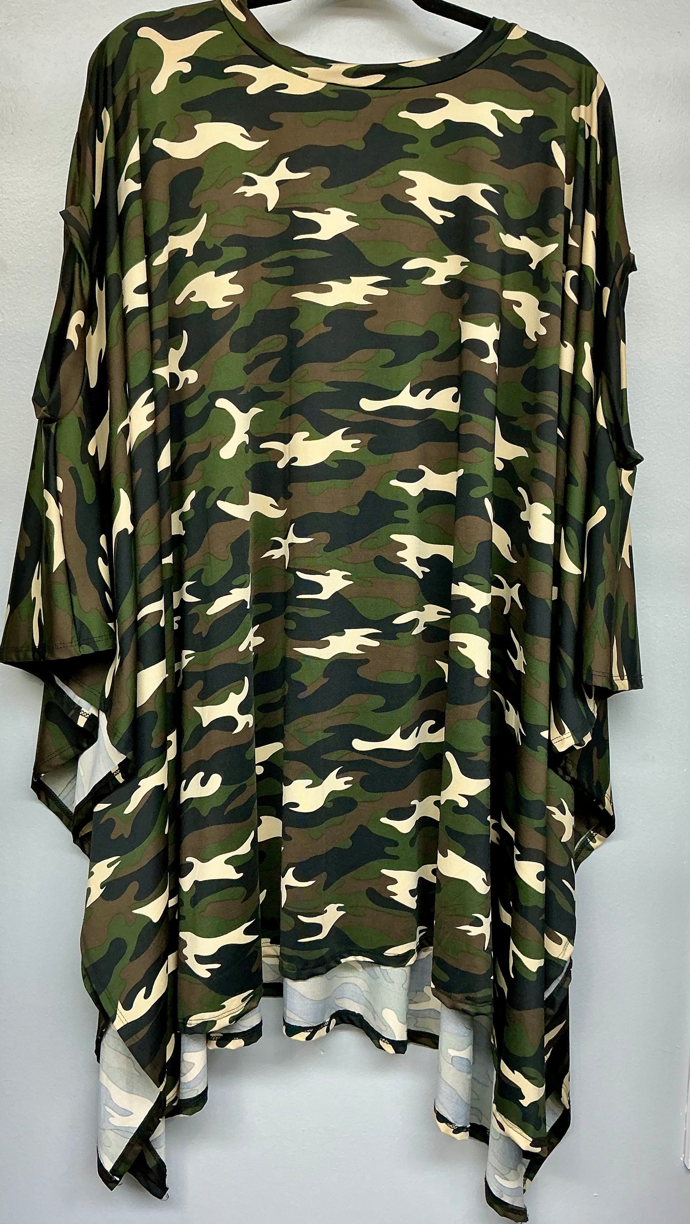 Camouflage-patterned dress on a hanger against a white background