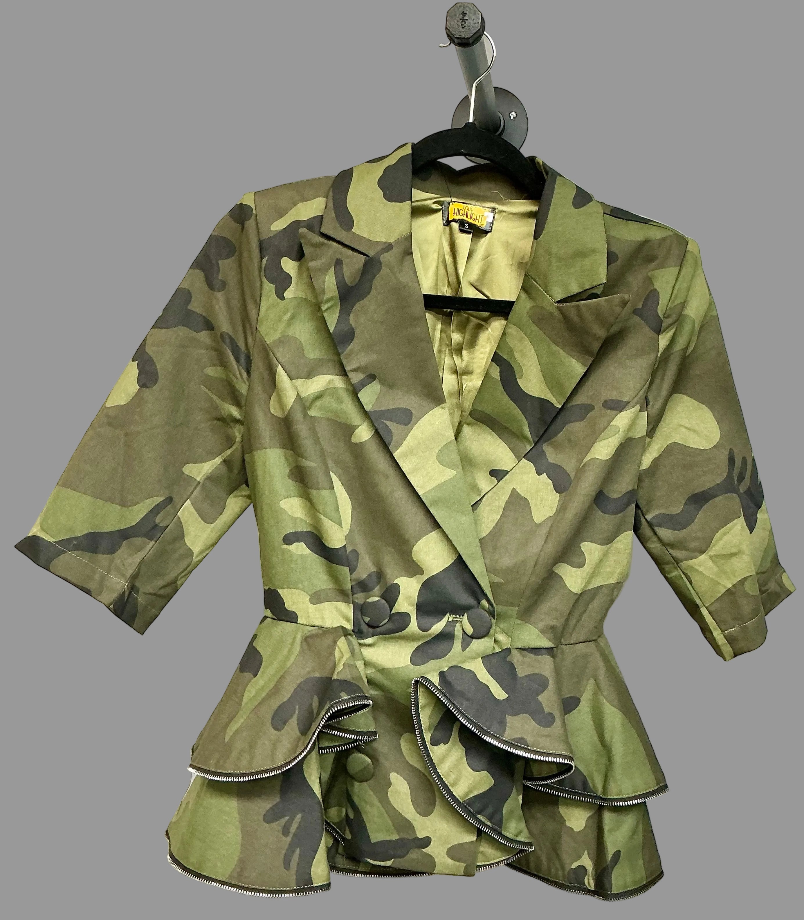 Camouflage jacket with ruffled details on a white background