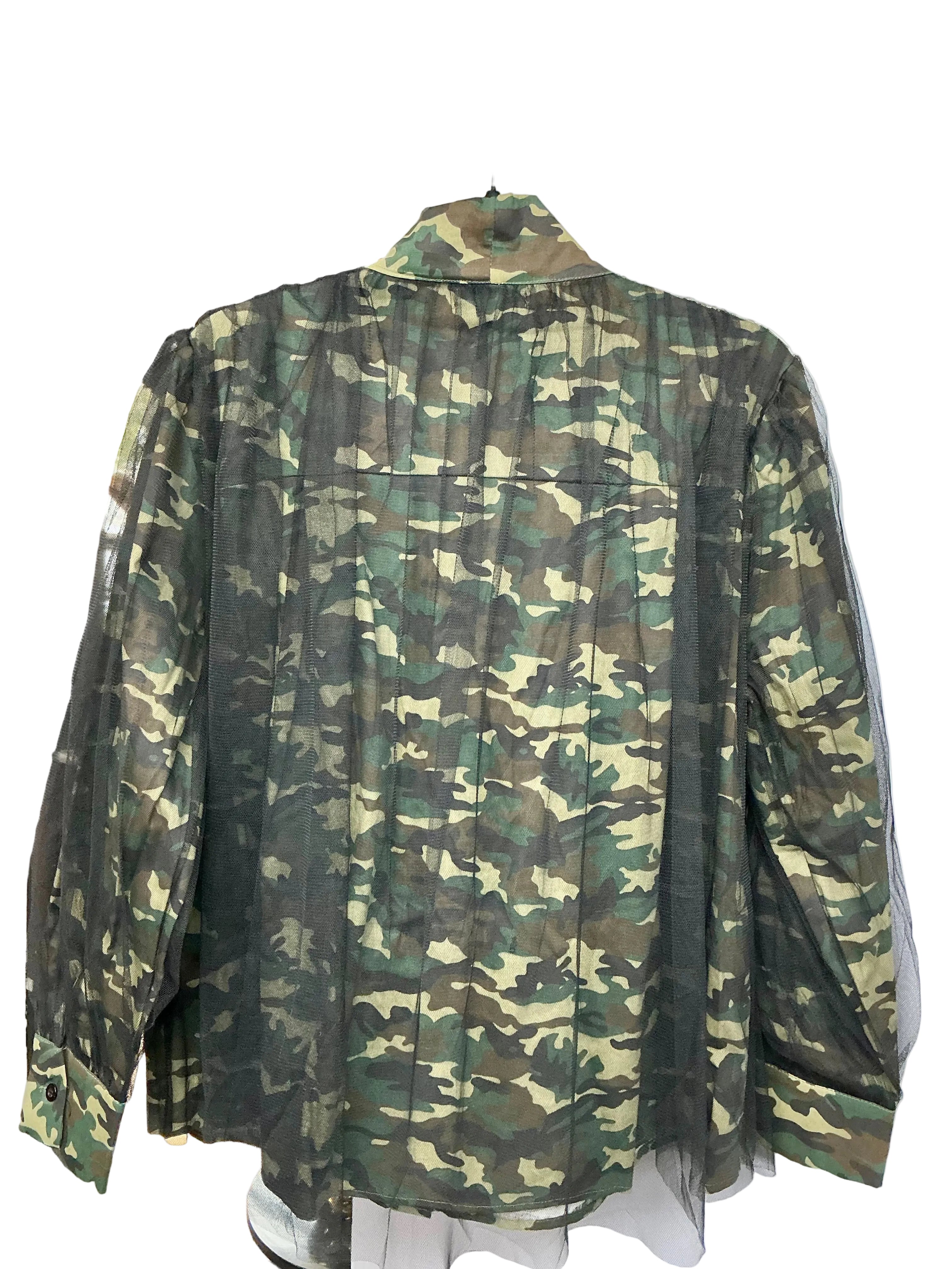 Back view of camouflage-patterned shirt with a white wall background