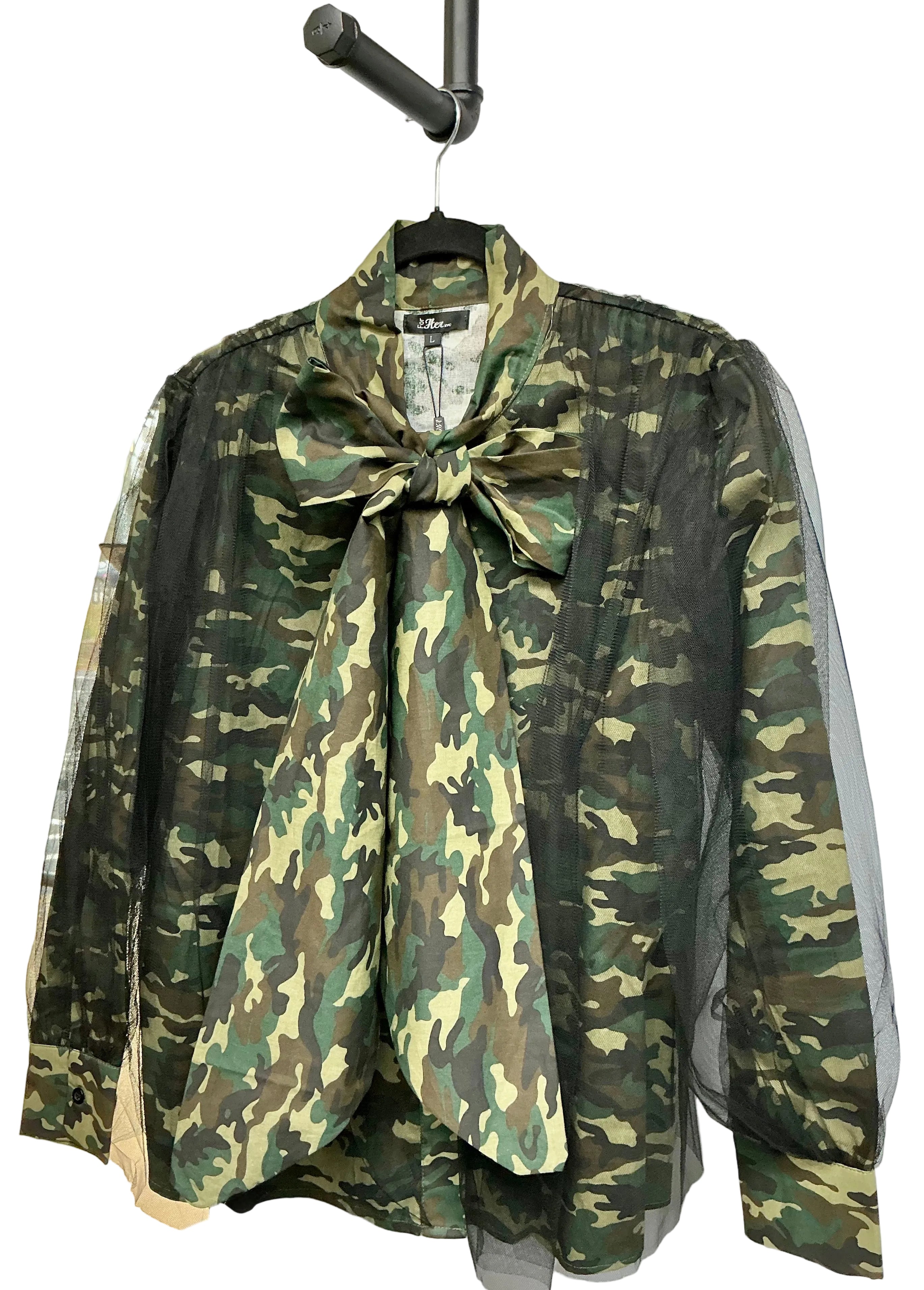 Camouflage shirt with black mesh overlay with a large bow on a hanger against a white background