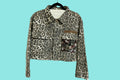 Leopard print jacket with a floral pocket on a white background