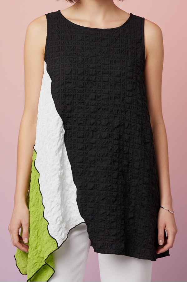 A color blocked (black, white and lime green) sleeveless top with a ruffled, crinkled pattern and an asymmetrical handkerchief hem on model