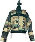 Camouflage jacket with black mesh panels on a mannequin against a white background