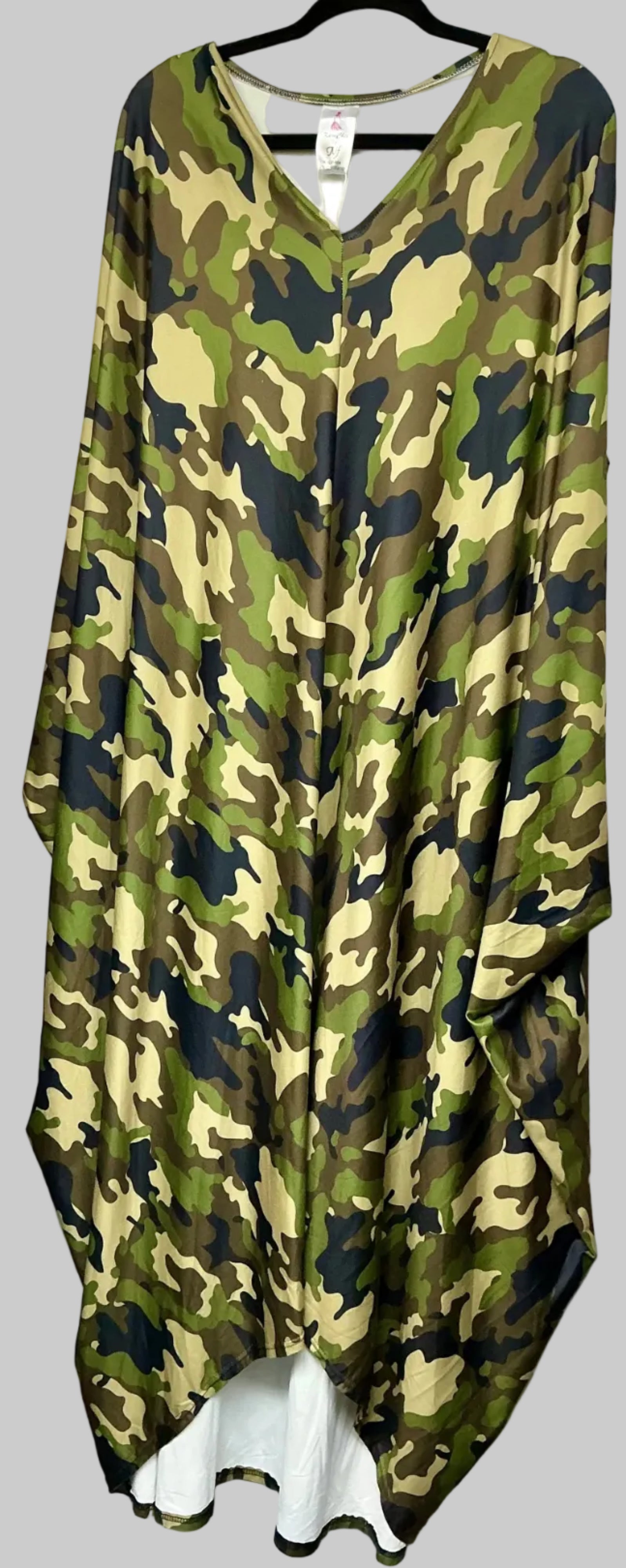 Camouflage-patterned garment on a hanger against a white background