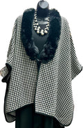 Houndstooth patterned coat with black fur trim on a mannequin.