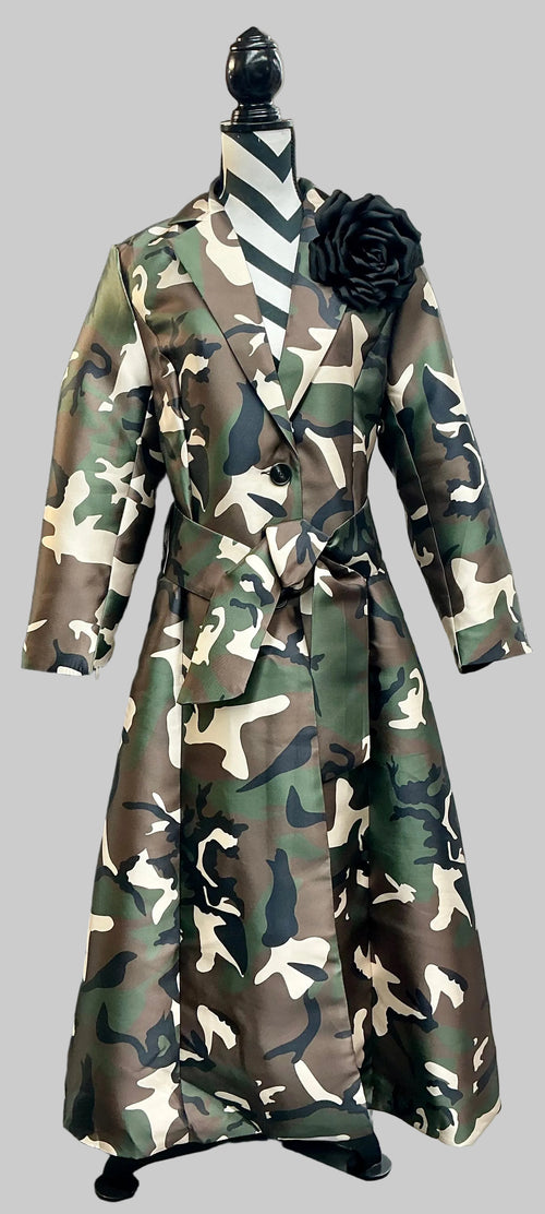 Camouflage coat displayed on a mannequin with a black flower accessory.